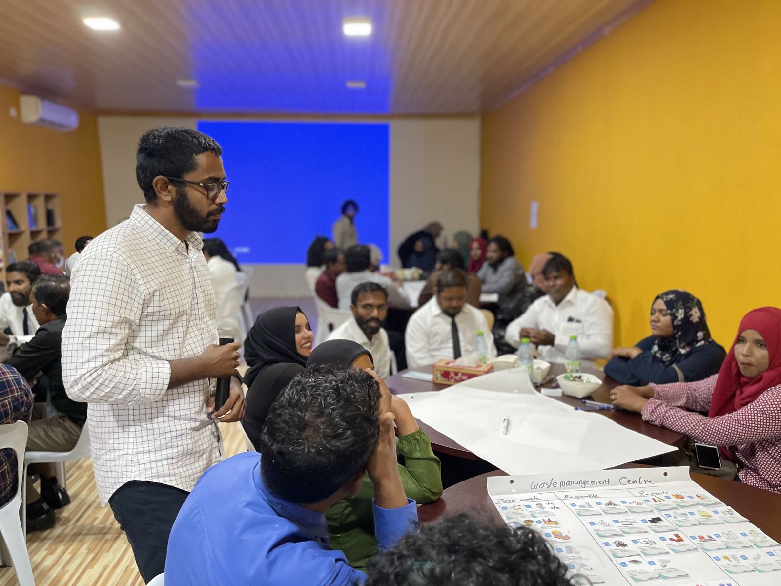 Participants around tables during a Noonu Atoll workshop