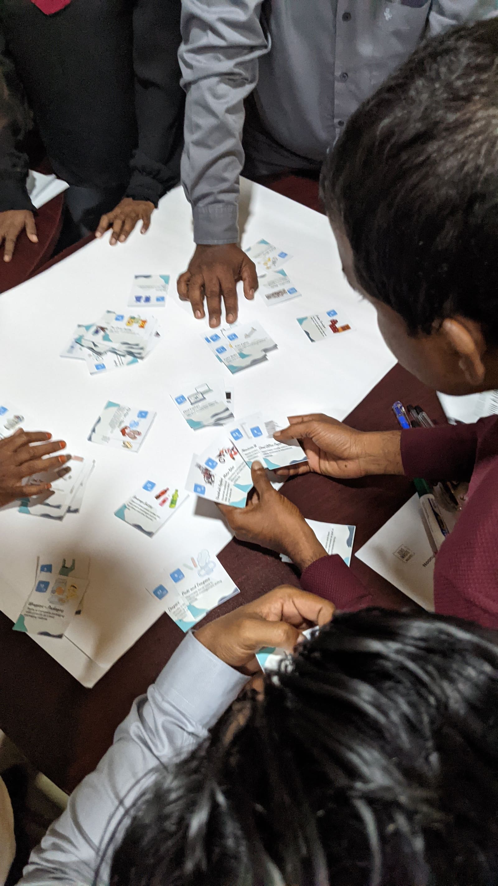 Participants sorting toolkit cards on a table